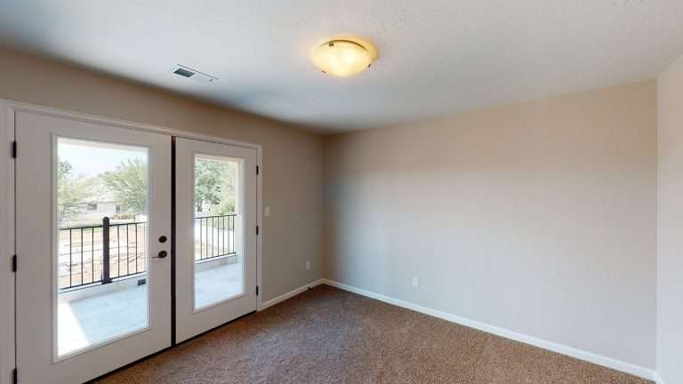 The Diamante room with balcony doors, new home by Integrity Homes in Western Colorado