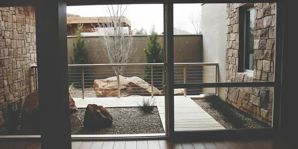 New construction landscaping in Grand Junction featuring a xeriscape design with stone walls and boulders.